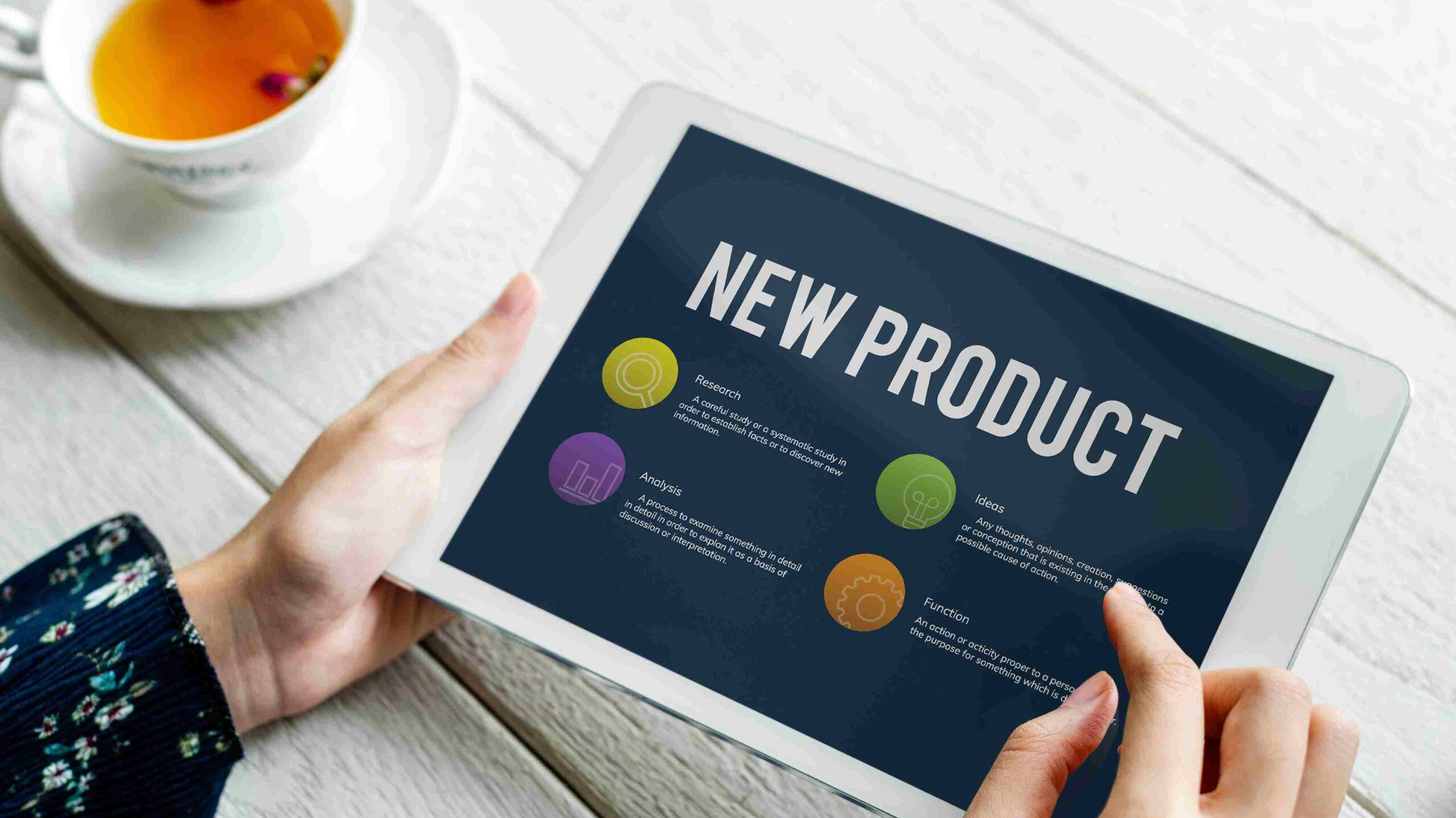 Brand owner researching a cosmetic contract manufacturing expansion strategy on a tablet. New product line development in cosmetic contract manufacturing starts with in-depth research. A local cosmetic brand expansion strategy covers research, analysis, and product ideas.